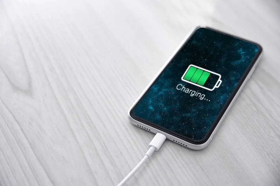 携帯電話が充電器に接続されています。